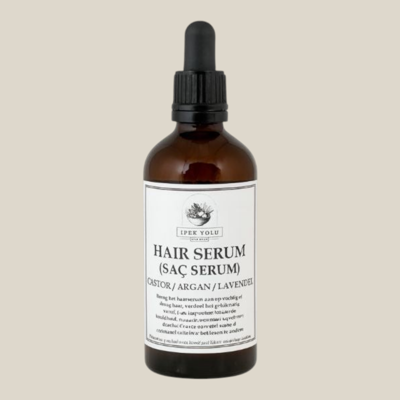 TuanaShop BV haarserum in bruine glazen fles met pipet, verrijkt met castor-, argan- en lavendelolie voor gezond haar.